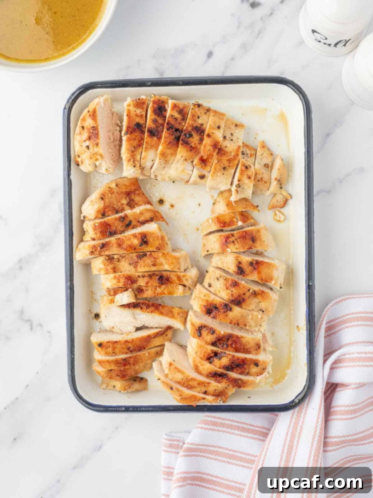 Fall Harvest Chopped Chicken Salad 5 Grilled chicken breasts, perfectly cooked and sliced, arranged on a platter.