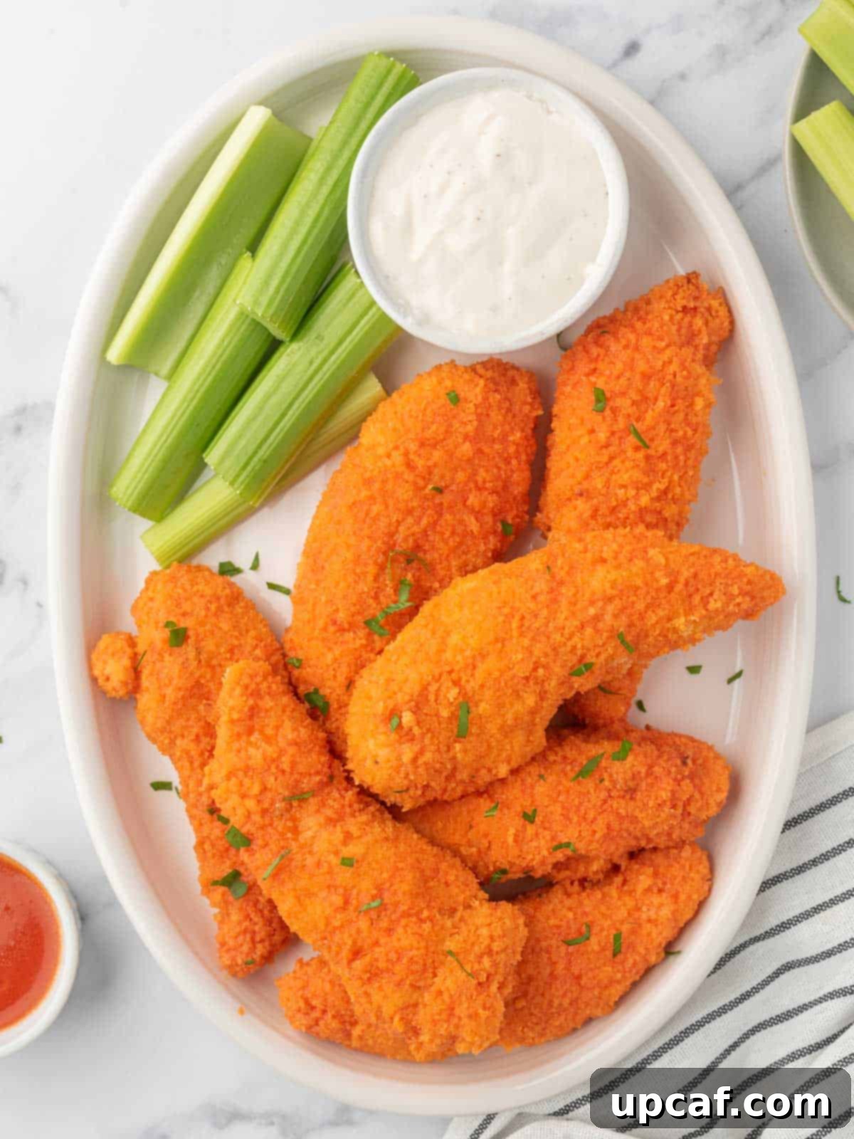 A plate of crispy buffalo chicken strips.