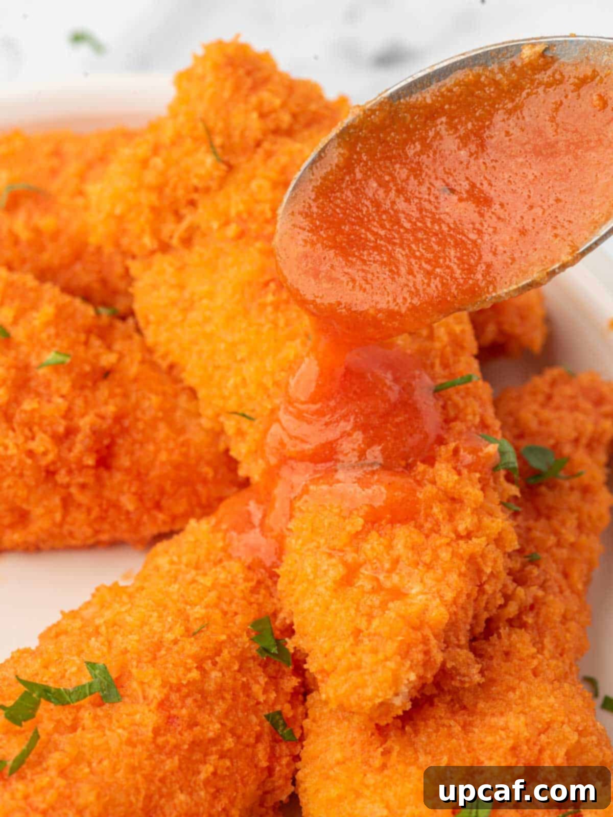 Drizzle buffalo sauce over crispy chicken tenders.