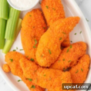 A plate of buffalo chicken fingers with celery and dip.