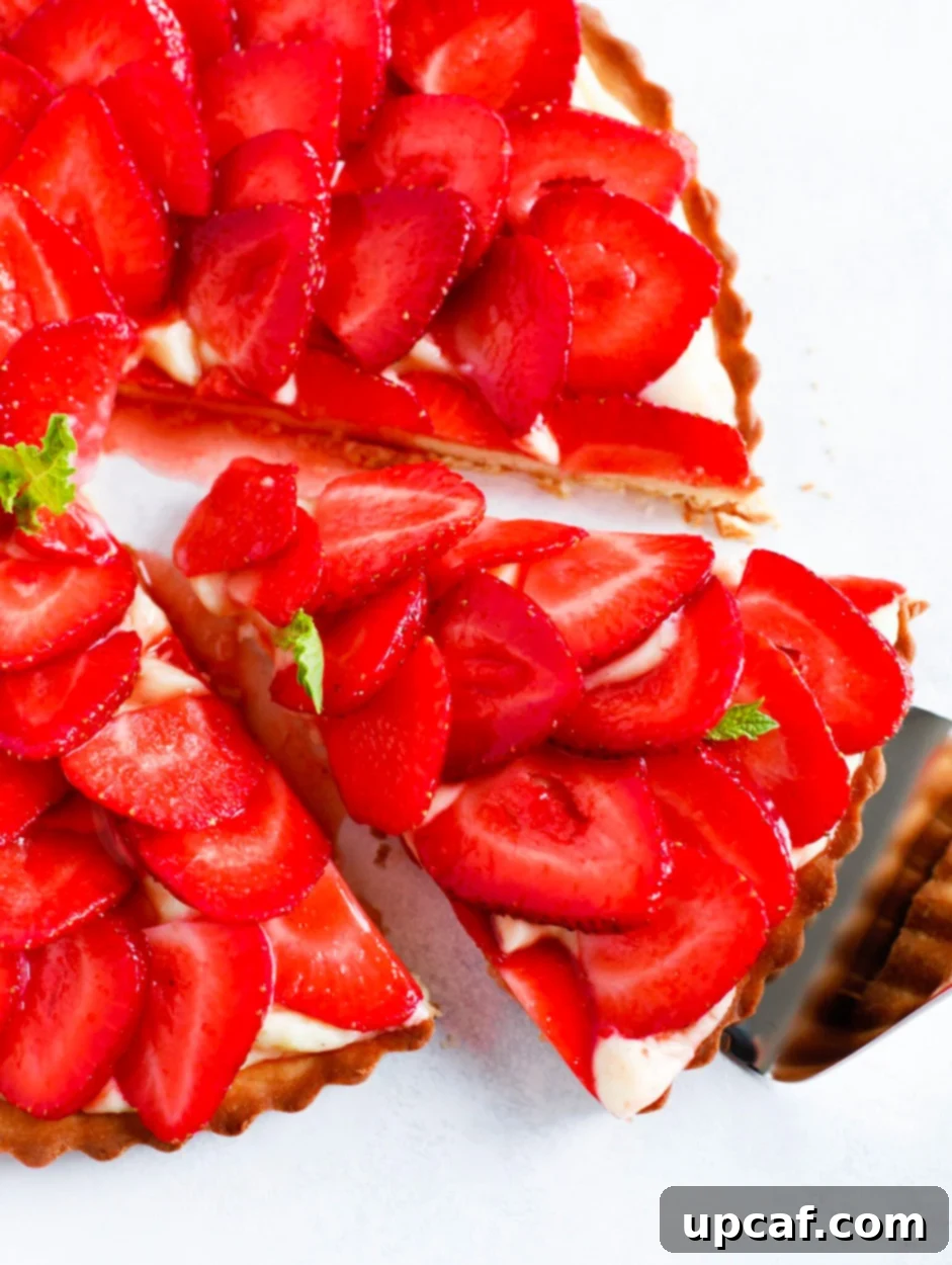 The Secret to Silky Crème Pâtissière 11 Strawberry French Tarte with a slice being taken out.