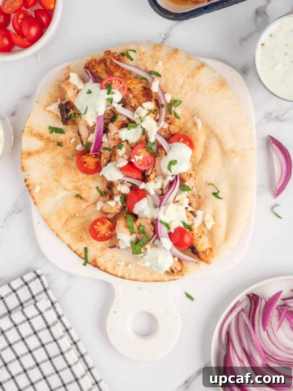 Assembled gyro chicken recipe on a platter, ready to be served.