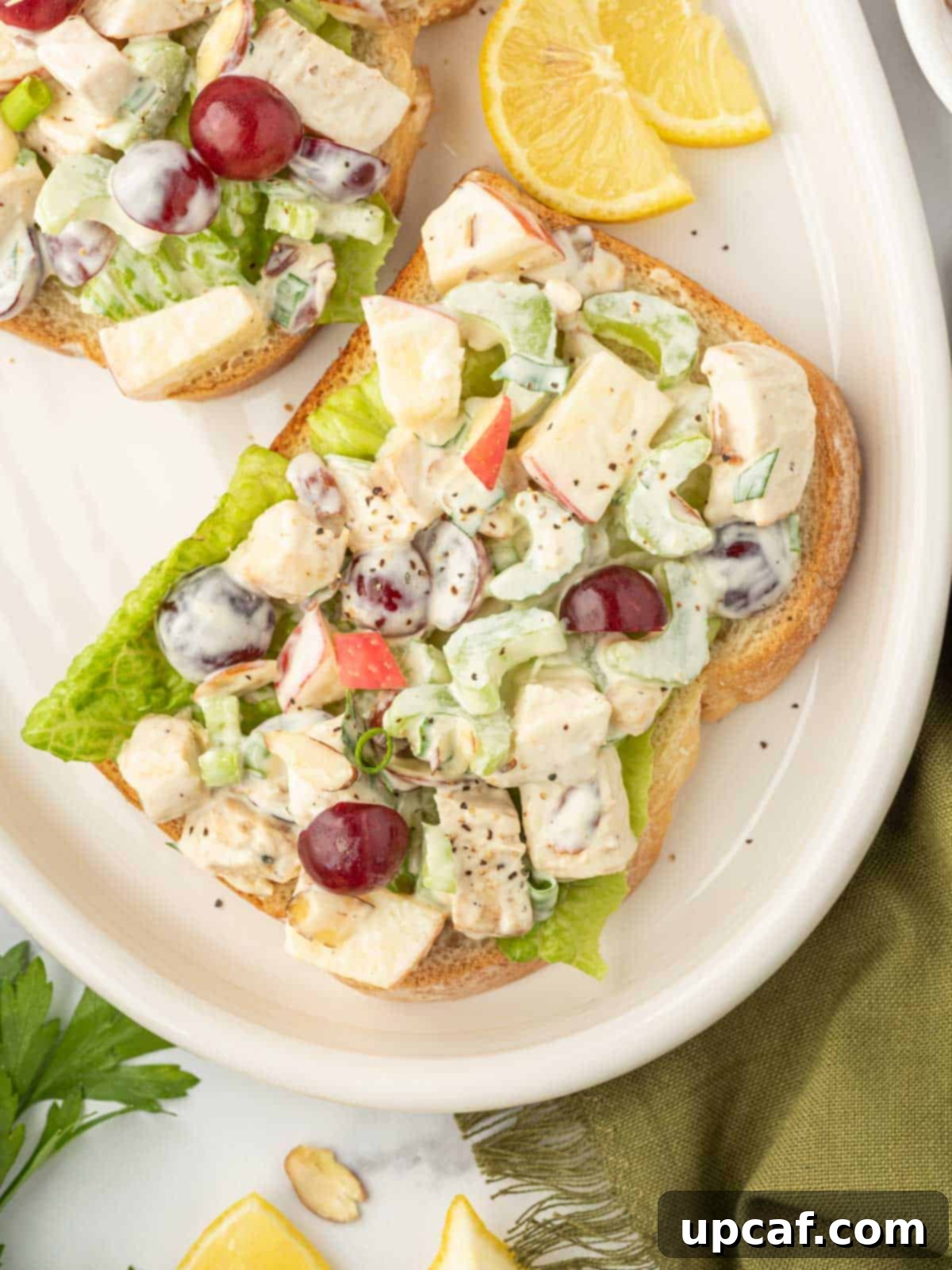 Our Family's Best Chicken Salad 8 Healthy chicken salad on toast on a serving plate.