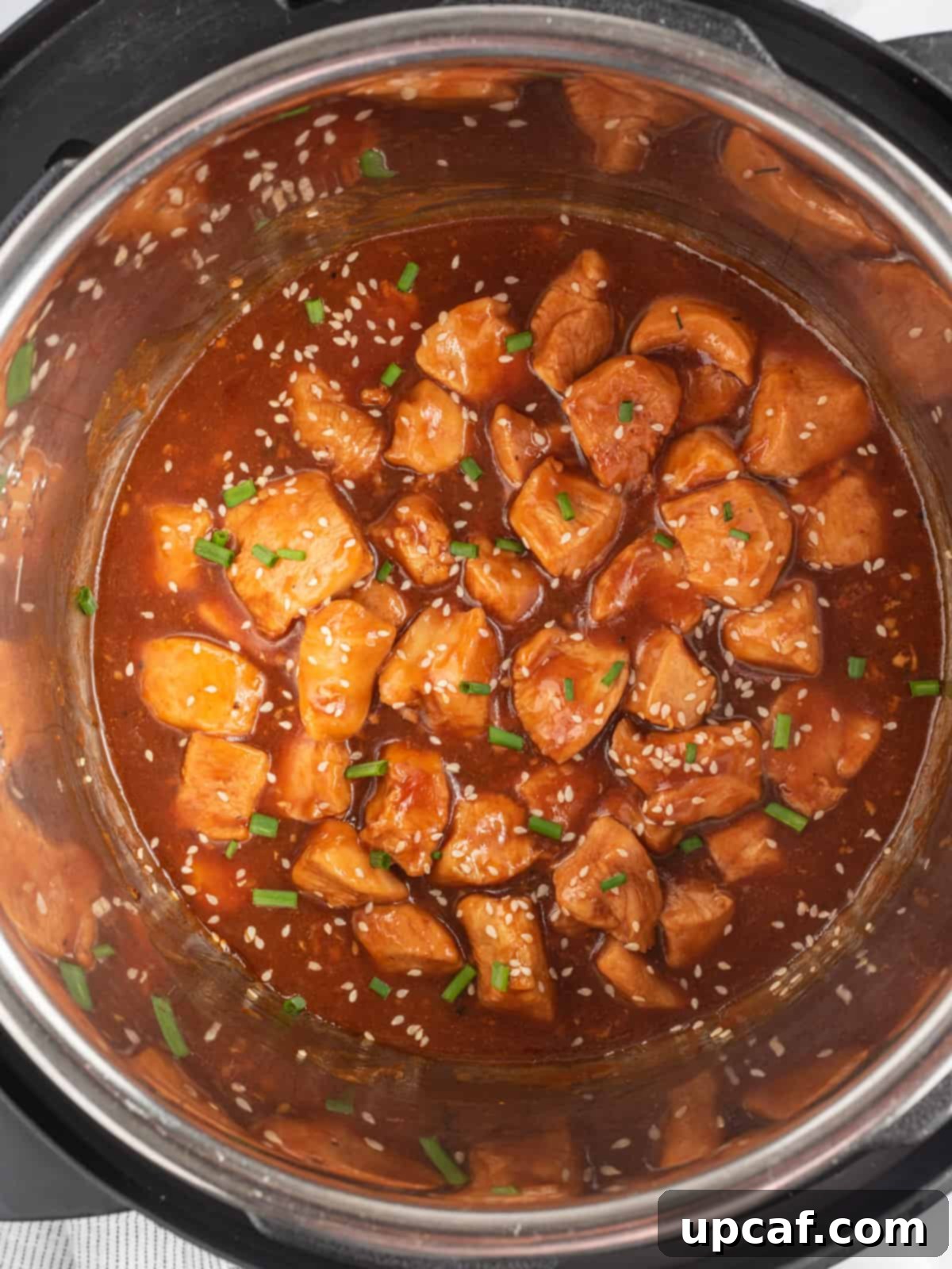 Instant Pot insert filled with chucks of chicken in sesame sauce.