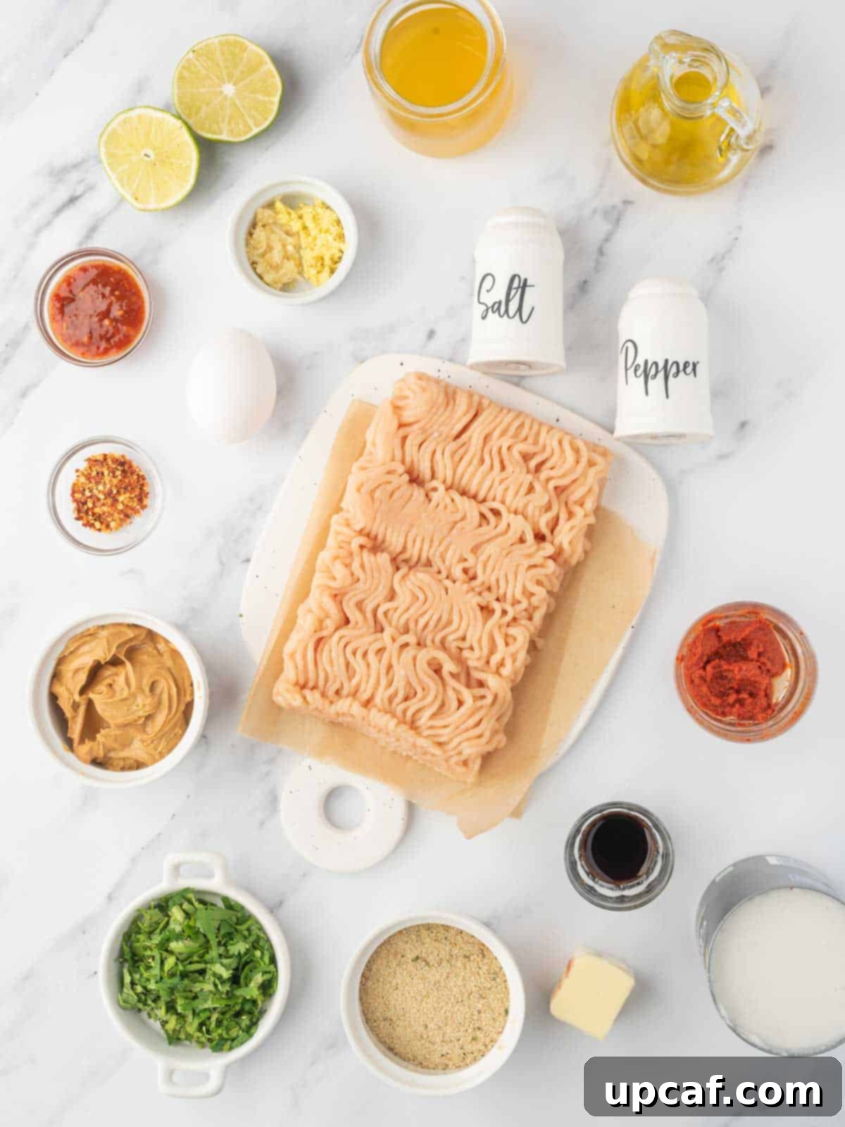 Thai Spiced Chicken Meatballs 3 A vibrant selection of fresh ingredients laid out, including ground chicken, eggs, breadcrumbs, cilantro, garlic, ginger, and red pepper flakes, ready for making Thai ground chicken meatballs.