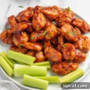 Chicken bites on a plate with celery.