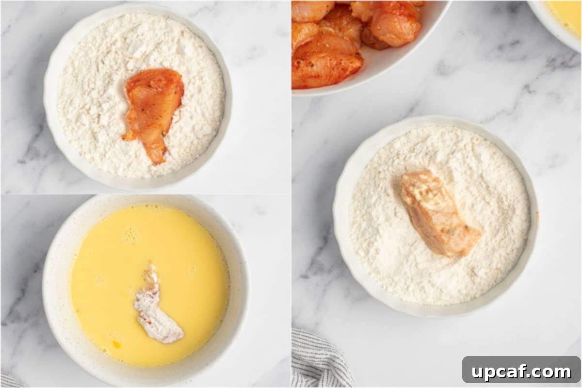 The process of dredging seasoned chicken, first in flour, then in egg mixture, for a thorough coating.