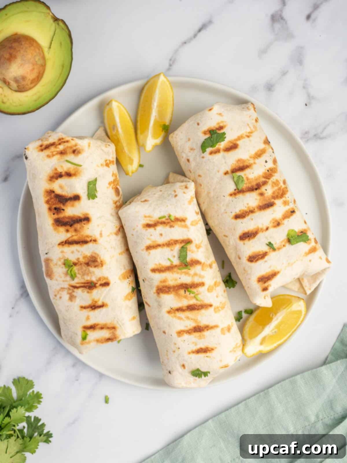 Creamy Avocado Chicken Wrap 6 Healthy chicken wrap with grill marks on a platter.