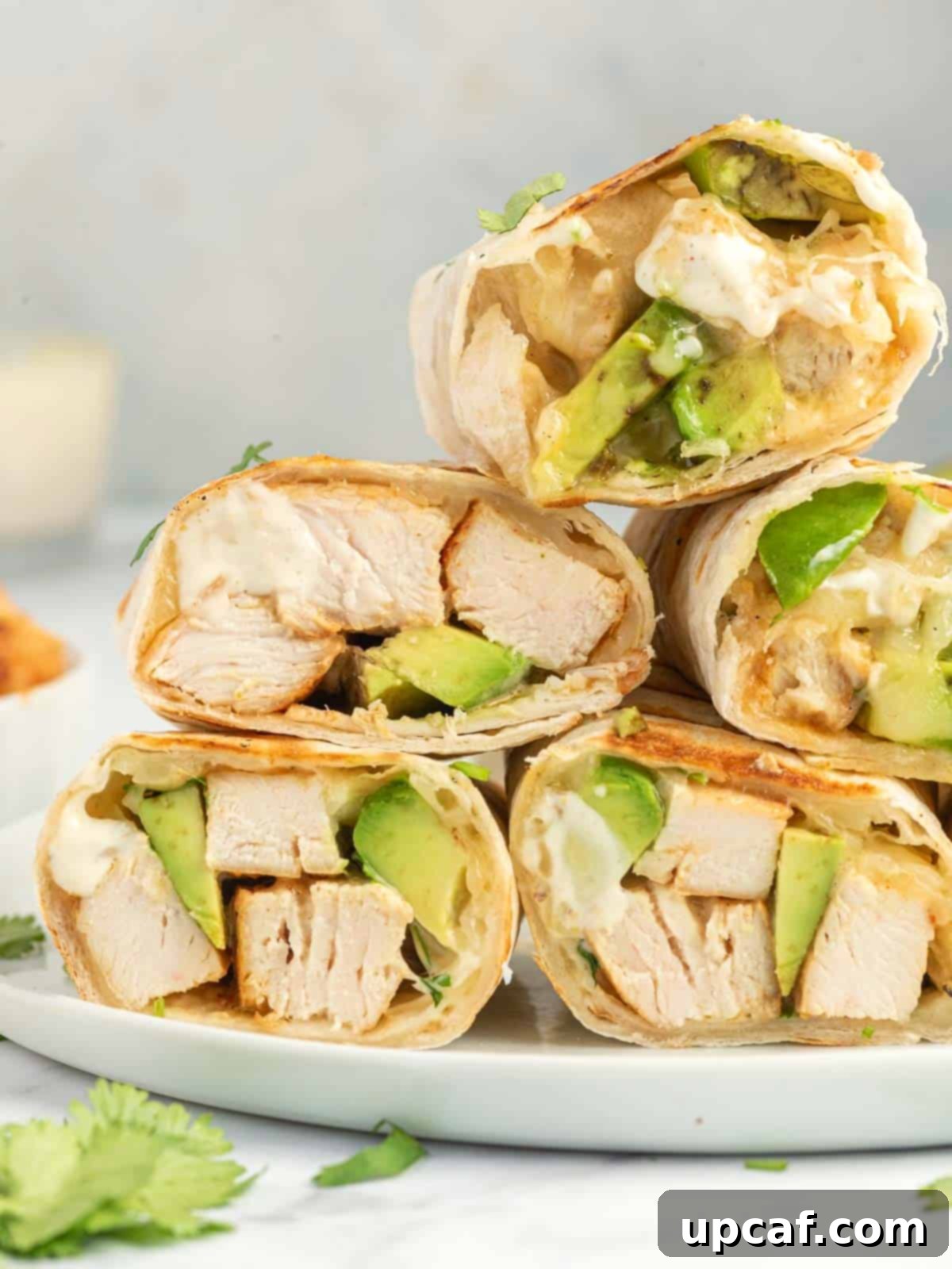Creamy Avocado Chicken Wrap 7 A stack of chicken avocado wraps ready to serve.