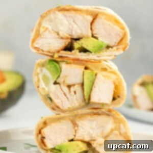Creamy Avocado Chicken Wrap 9 Grilled chicken, avocado and cheese in an easy chicken wrap stacked on a plate.