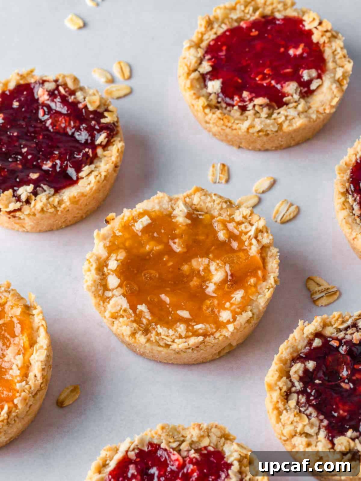 Oatmeal jam biscuits on a tray.