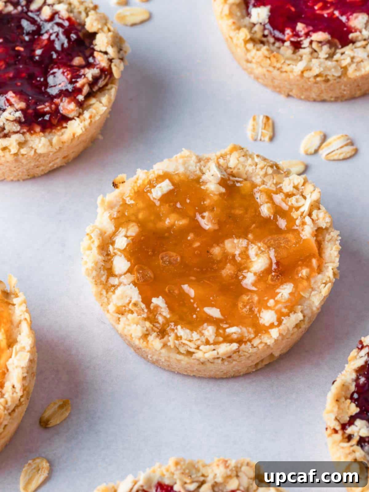 Cookies with jam filling on a tray.