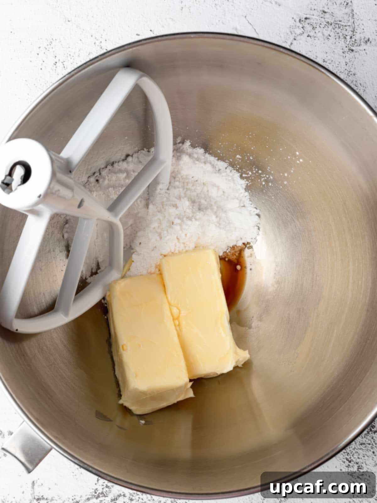 Buckeye Peanut Butter Temptations 4 A stand mixer bowl showing the process of creaming butter and sugar for the peanut butter dough.