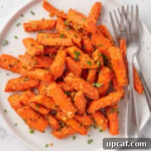 roasted carrots with parmesan cheese on a plate with two forks.