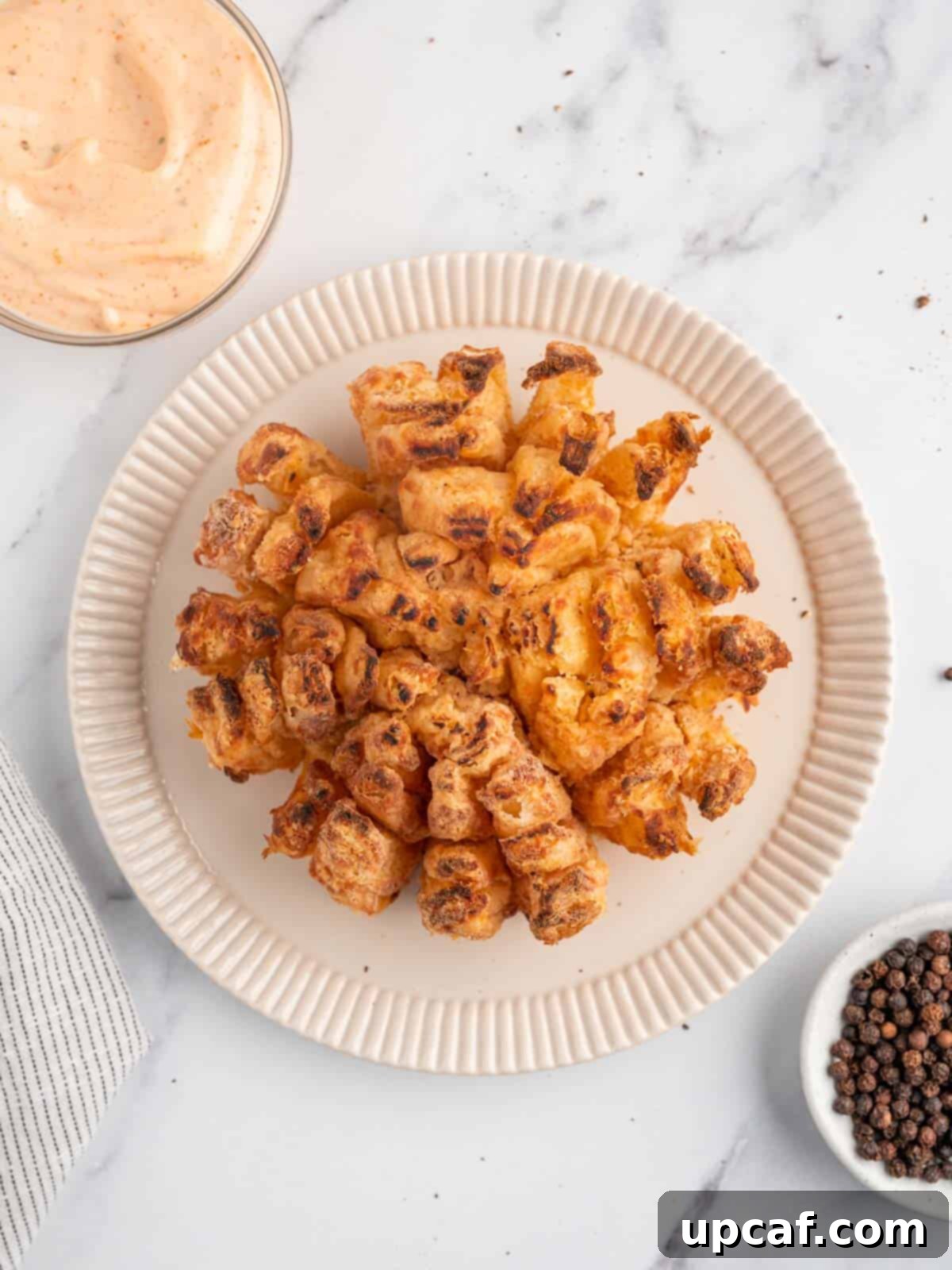 Blooming onion air fryer on a plate.