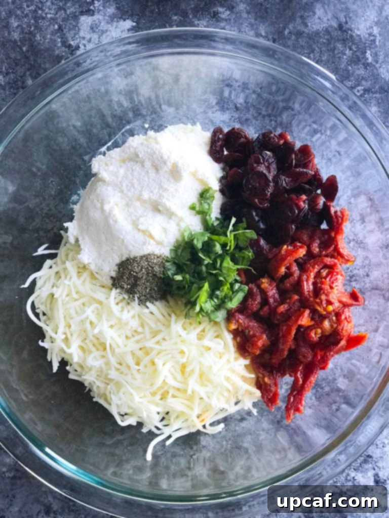 Mediterranean Chicken with Sun-Dried Tomatoes and Creamy Cheese 2 Ingredients for Cheesy Sundried Tomato Stuffed Chicken stuffing mixed in a bowl