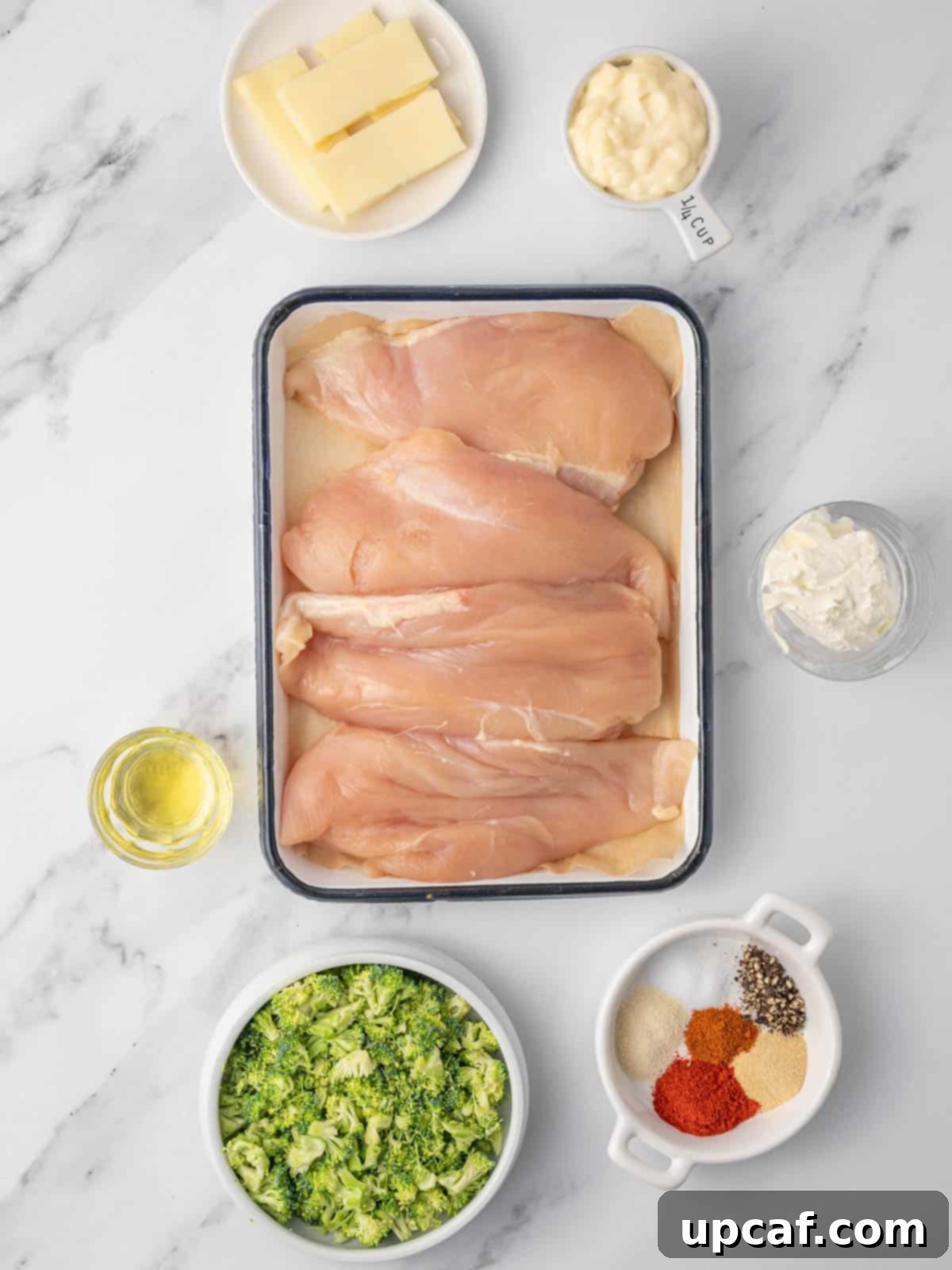 Ingredients needed for air fryer chicken breast, including chicken, broccoli, cream cheese, and spices.