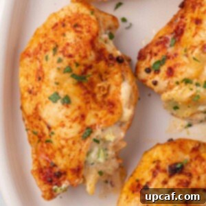 Close up of broccoli stuffed chicken on a platter, ready to serve.