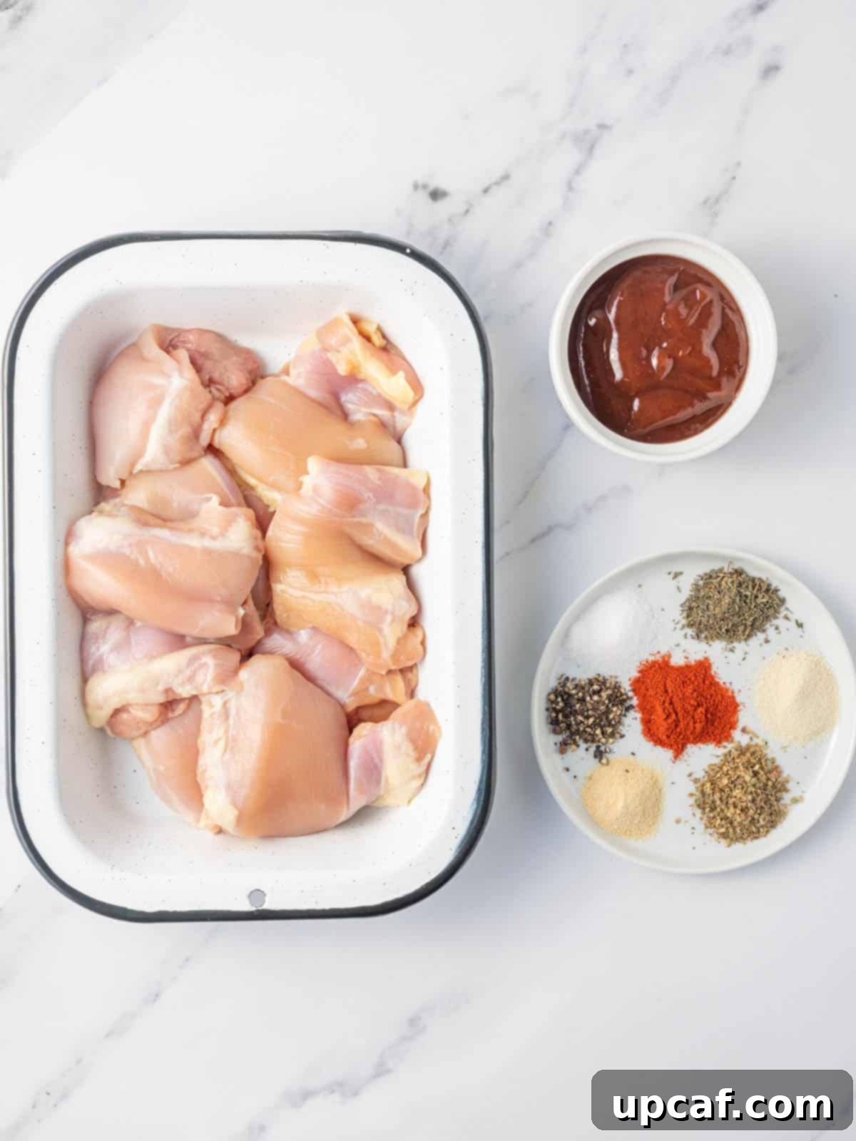 Ingredients needed for air fryer bbq chicken, including chicken thighs, spices, and barbecue sauce.