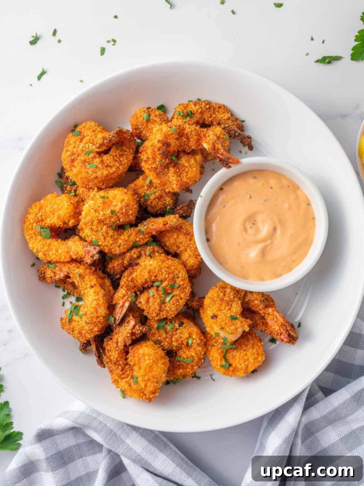 Air fried shrimp coated with almond flour on a plate.