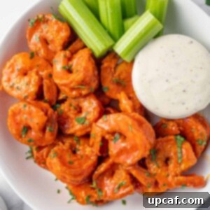 A plate of spicy fried shrimp and creamy dressing.