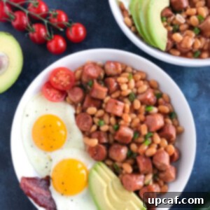 Baked Beans and Sausage in a white bowl, ready to eat