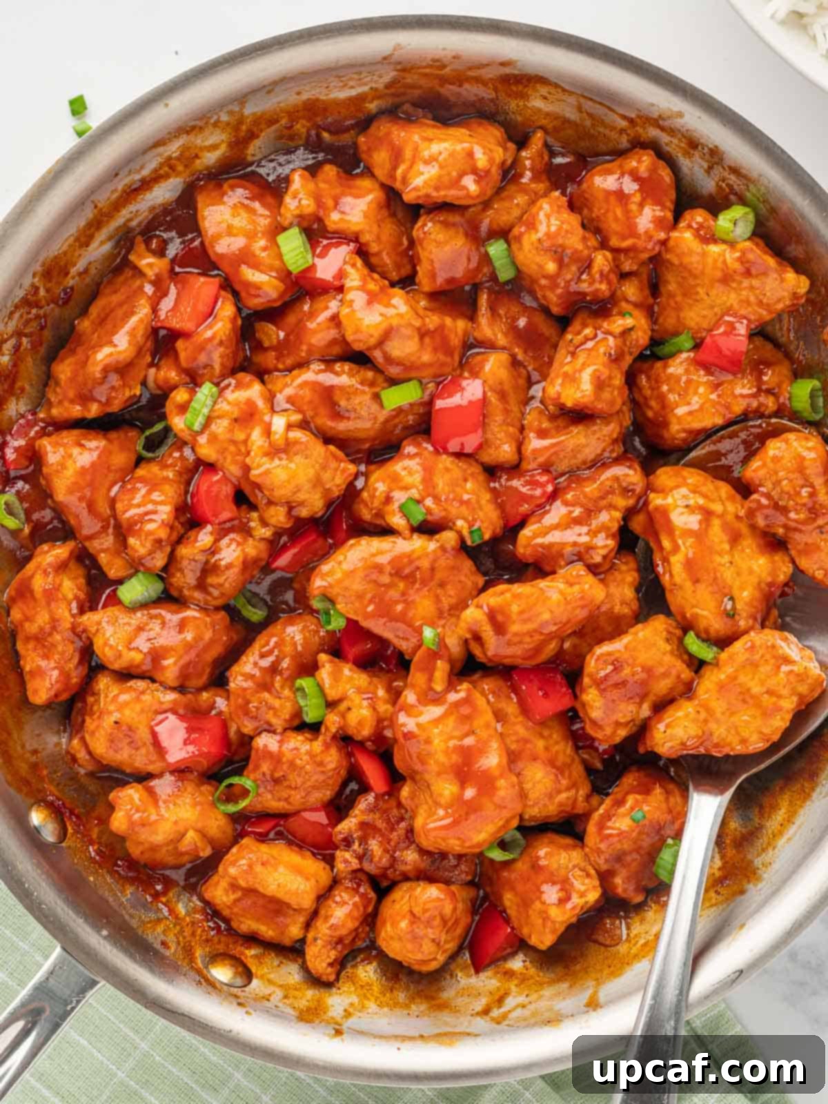 Crispy Garlic Chili Chicken 7 Crispy chicken pieces perfectly coated in the savory and glossy Manchurian sauce, glistening in a skillet ready to serve.