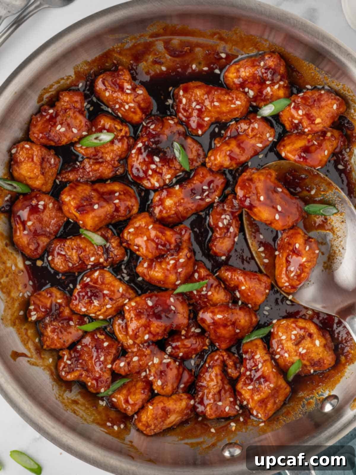 Sweet and spicy chicken in a skillet.