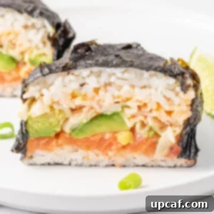 Close up of a sushi stuffed Japanese seaweed wrap.