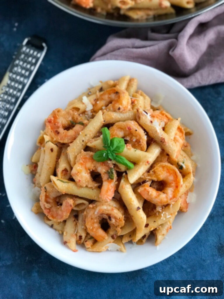 Creamy Shrimp Penne Pasta With Red Pepper Sauce top down shot of creamy shrimp in a bowl