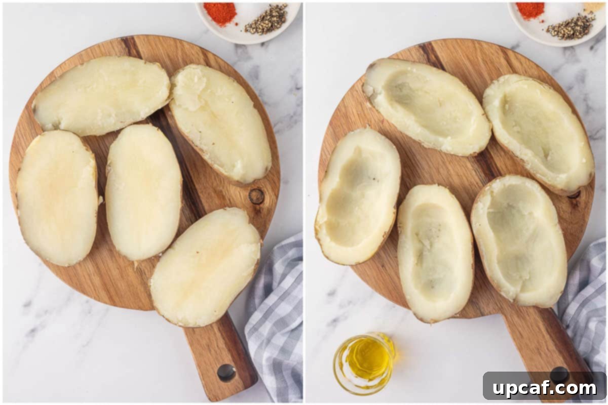 Crispy Air Fryer Potato Skins 4 Cooked potatoes on a board with the flesh scooped out for making potato skins.