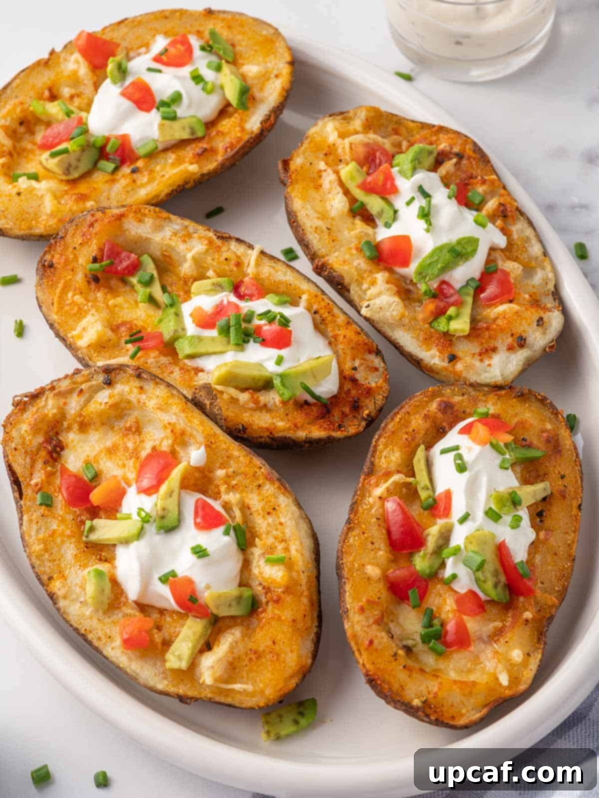 Crispy Air Fryer Potato Skins 7 Crispy potato skins topped with cheese, sour cream, avocado and tomato.