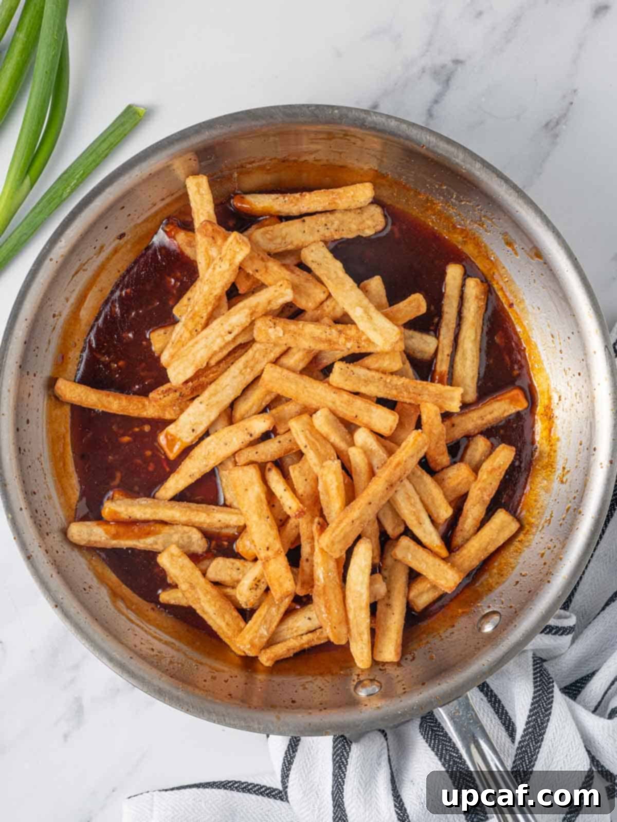 Spicy Honey Glazed Potatoes 7 Tossing fries in spicy sauce.