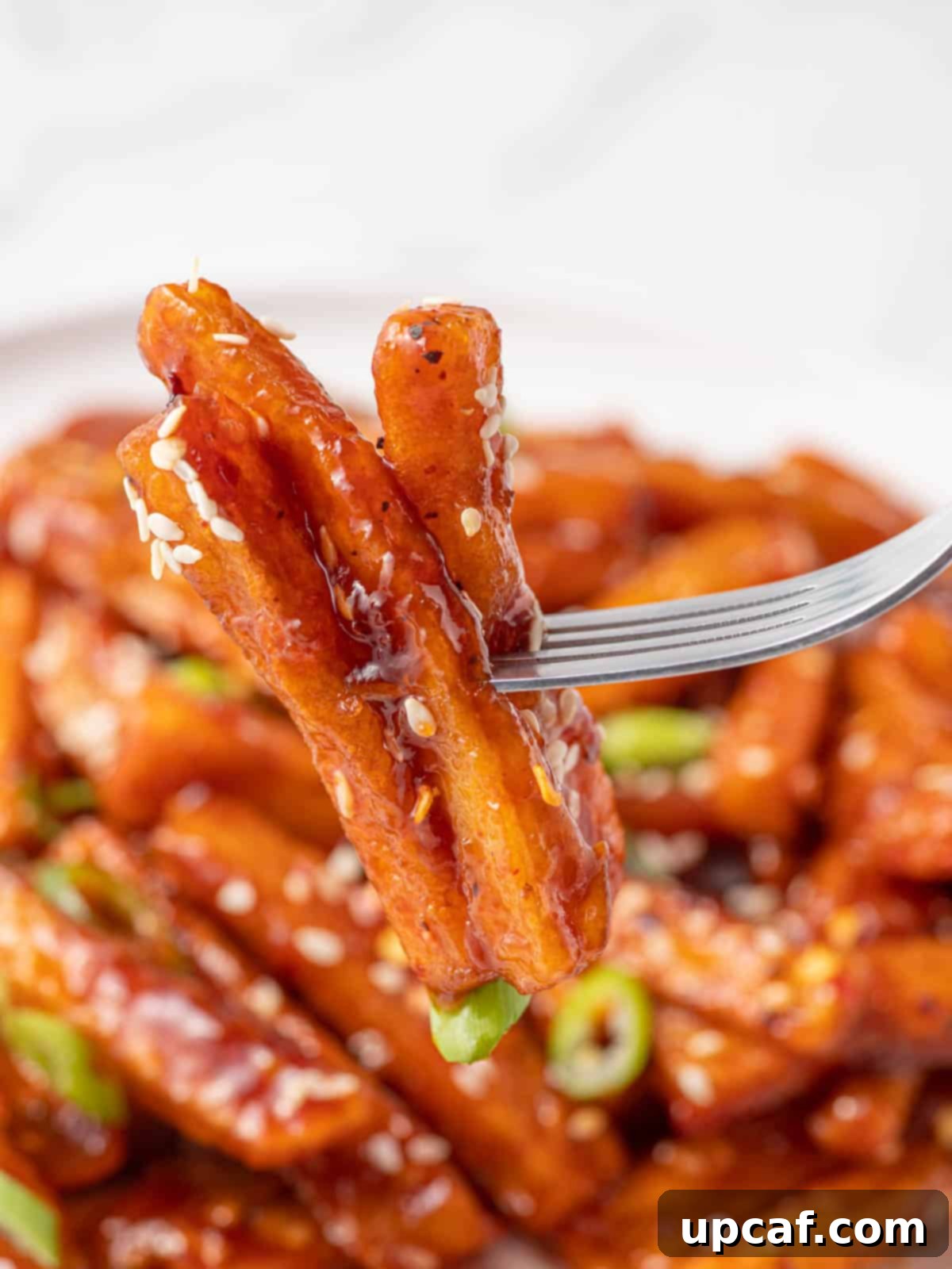 Spicy Honey Glazed Potatoes 10 A fork pick of a serving of stick sweet fries.