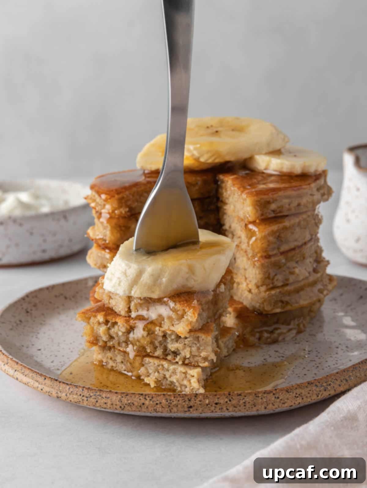 A fork picks up a bite of protein pancakes.