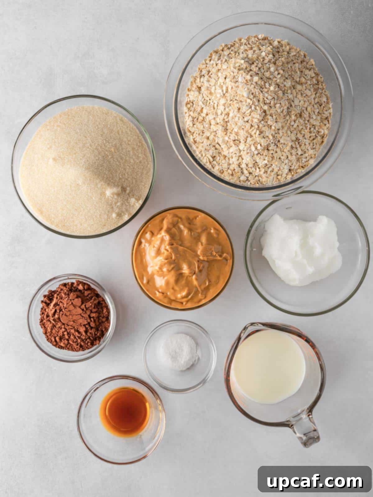A flat lay of all the essential ingredients needed for preparing gluten-free no-bake cookies, neatly arranged on a counter.