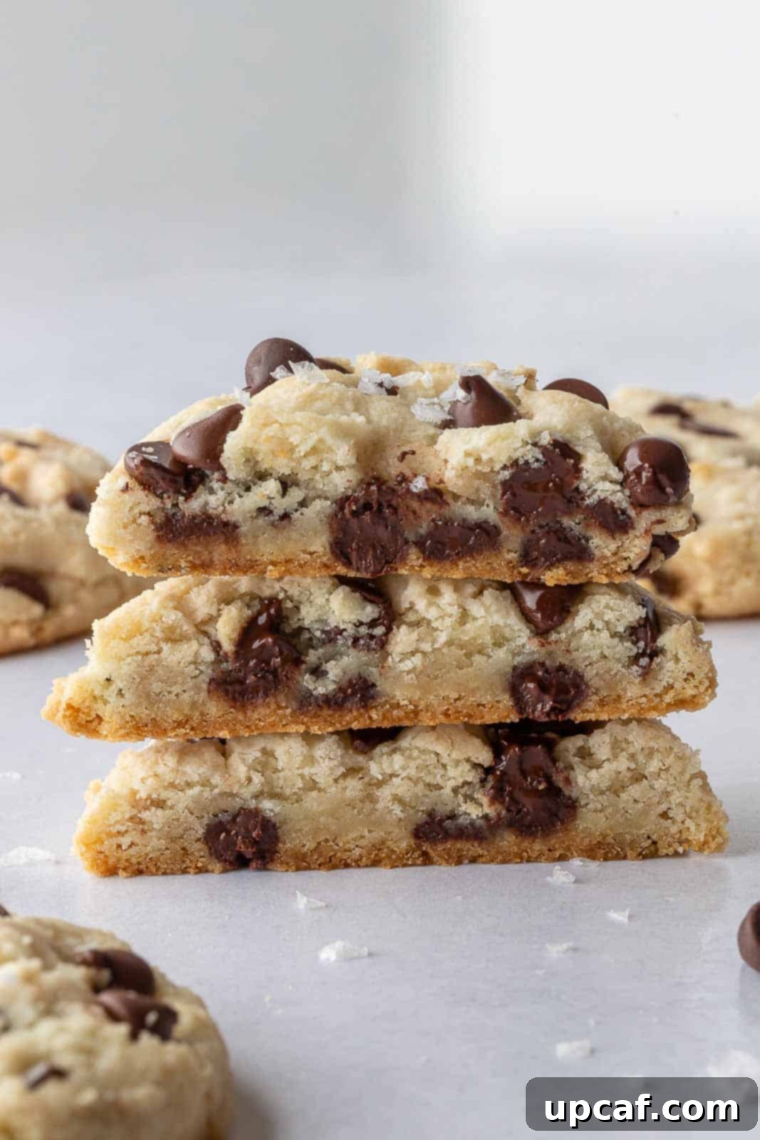 A pile of perfectly baked vegan chocolate chip cookies, stacked and ready to be enjoyed.
