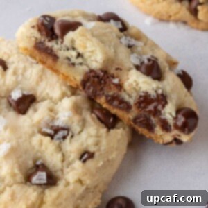 A soft and chewy cookie with a bite taken from it lays on top of another cookie.