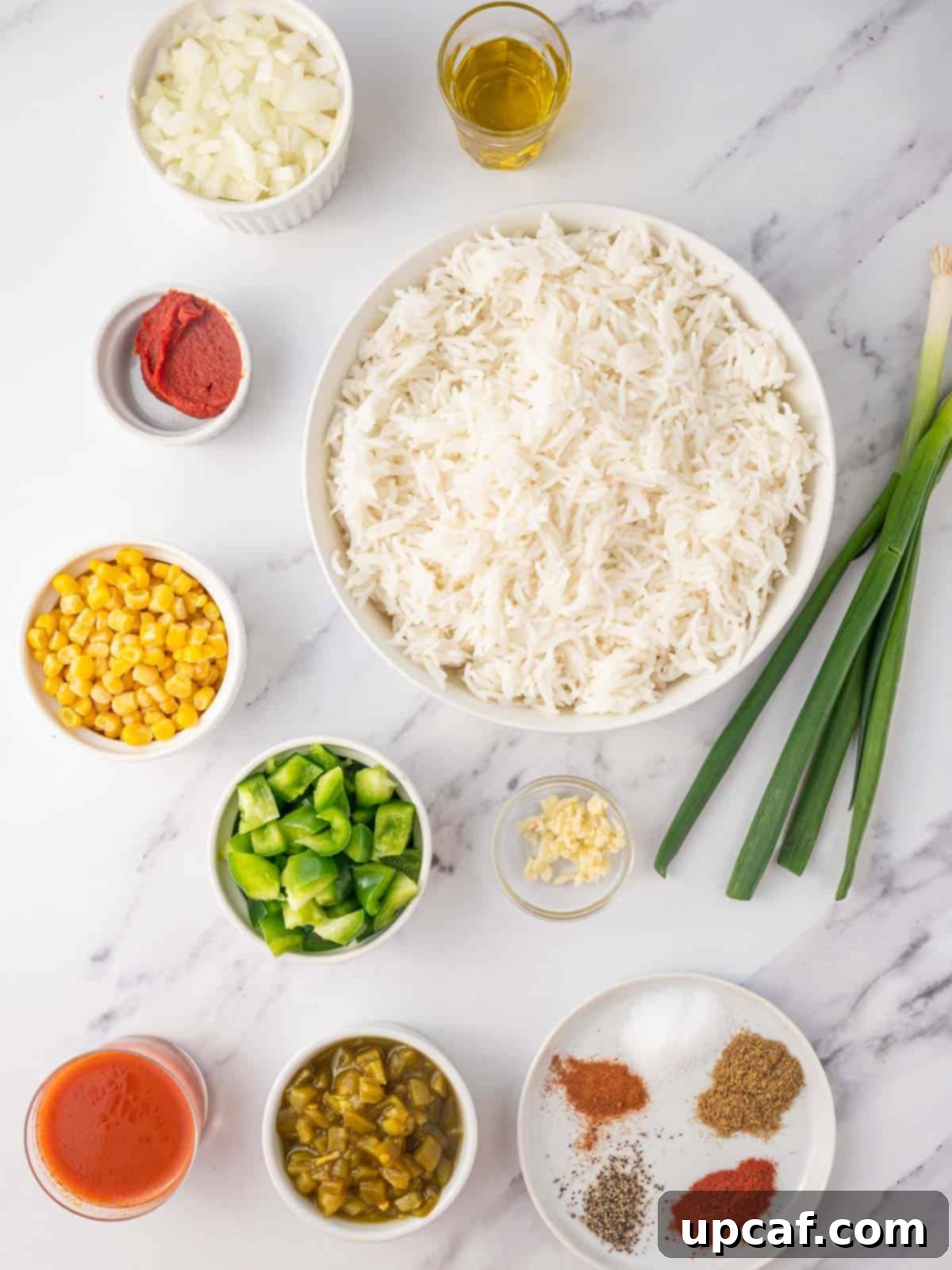 A vibrant selection of fresh ingredients laid out, ready for making Mexican fried rice.