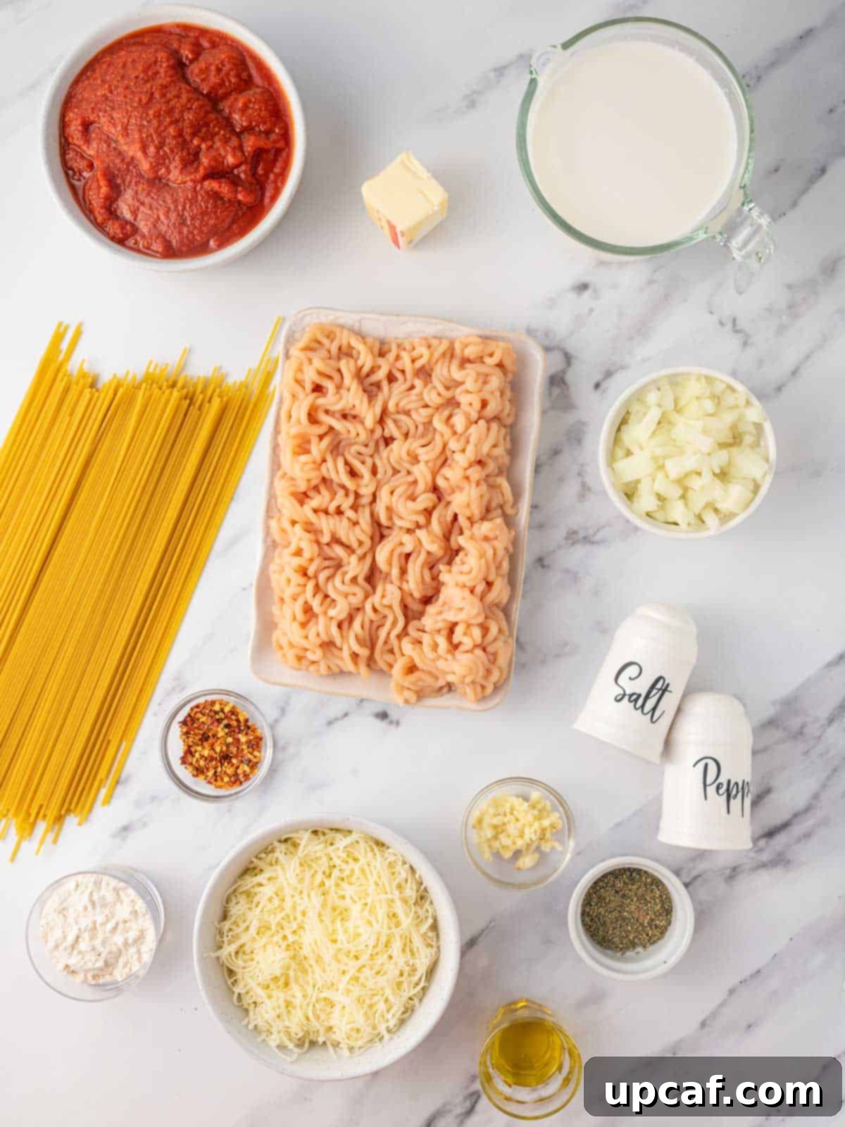 Ingredients needed for spaghetti alfredo, neatly laid out on a kitchen counter.