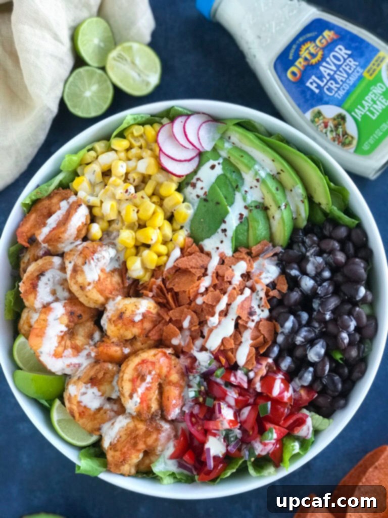 Shrimp Taco Bowl being topped with a delicious sauce, making it juicy and appealing