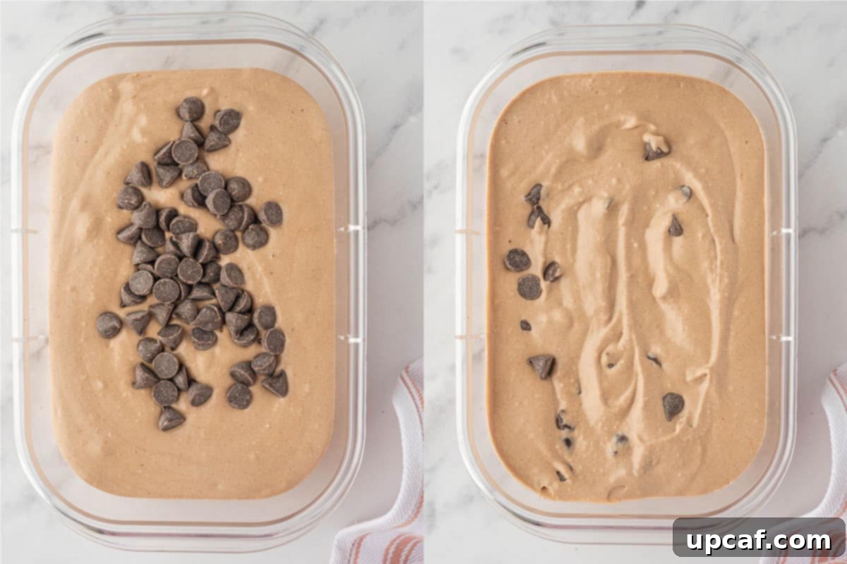 Milk chocolate chips being folded into the chocolate peanut butter cottage cheese ice cream mixture in a container.