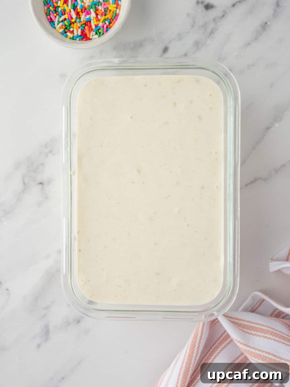 The blended vanilla ice cream base transferred to a freezer-safe container, ready for freezing.