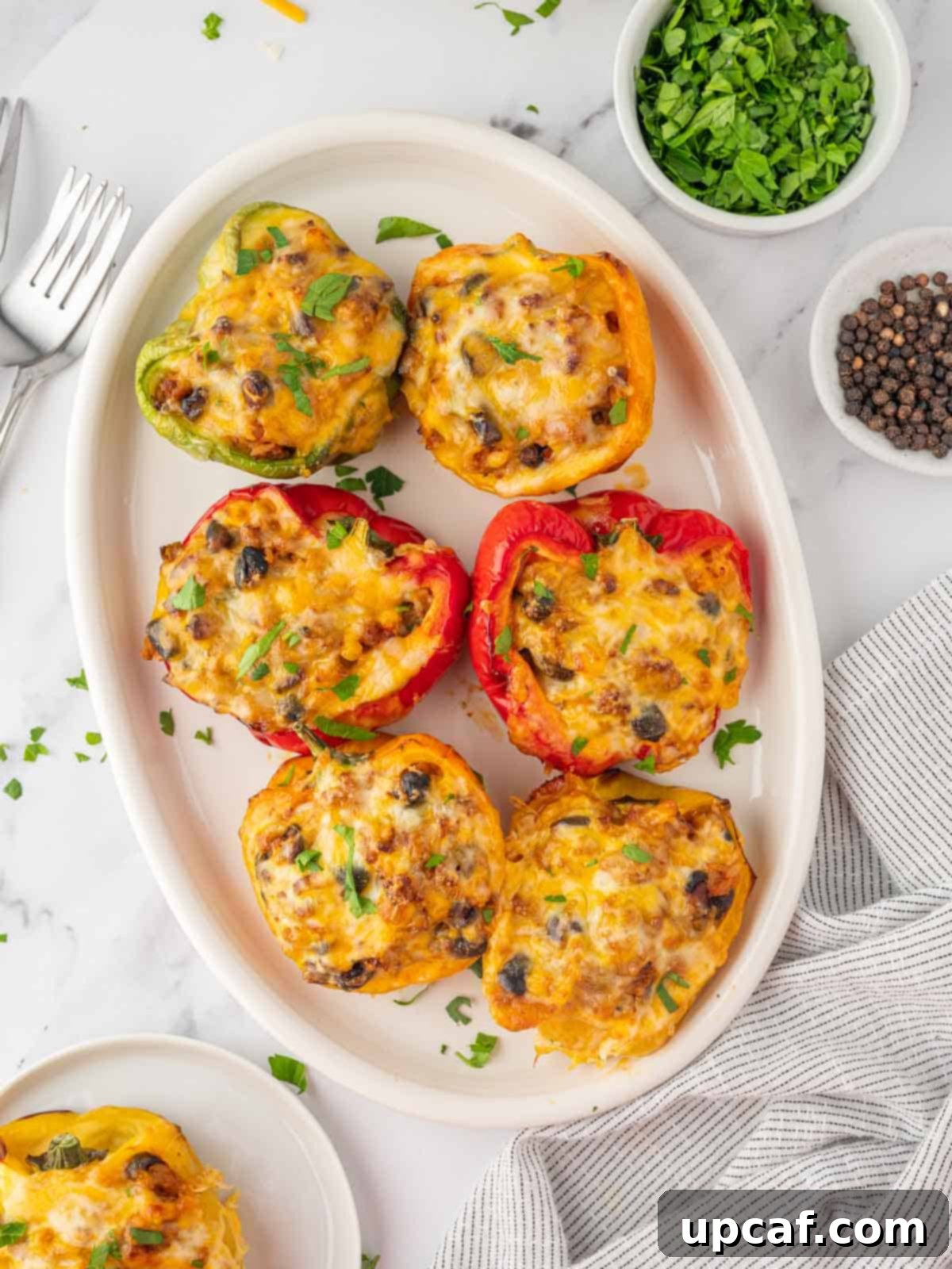 A vibrant platter of golden-brown taco stuffed peppers, freshly made and ready to serve.