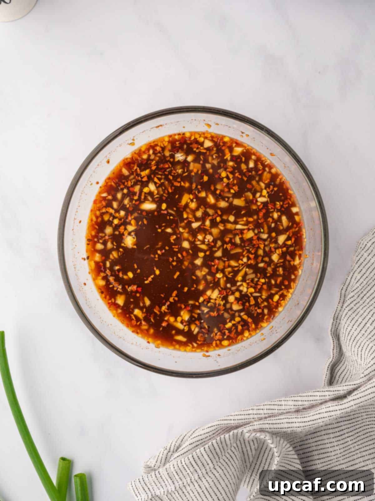 Spicy hunan chicken sauce in a bowl.