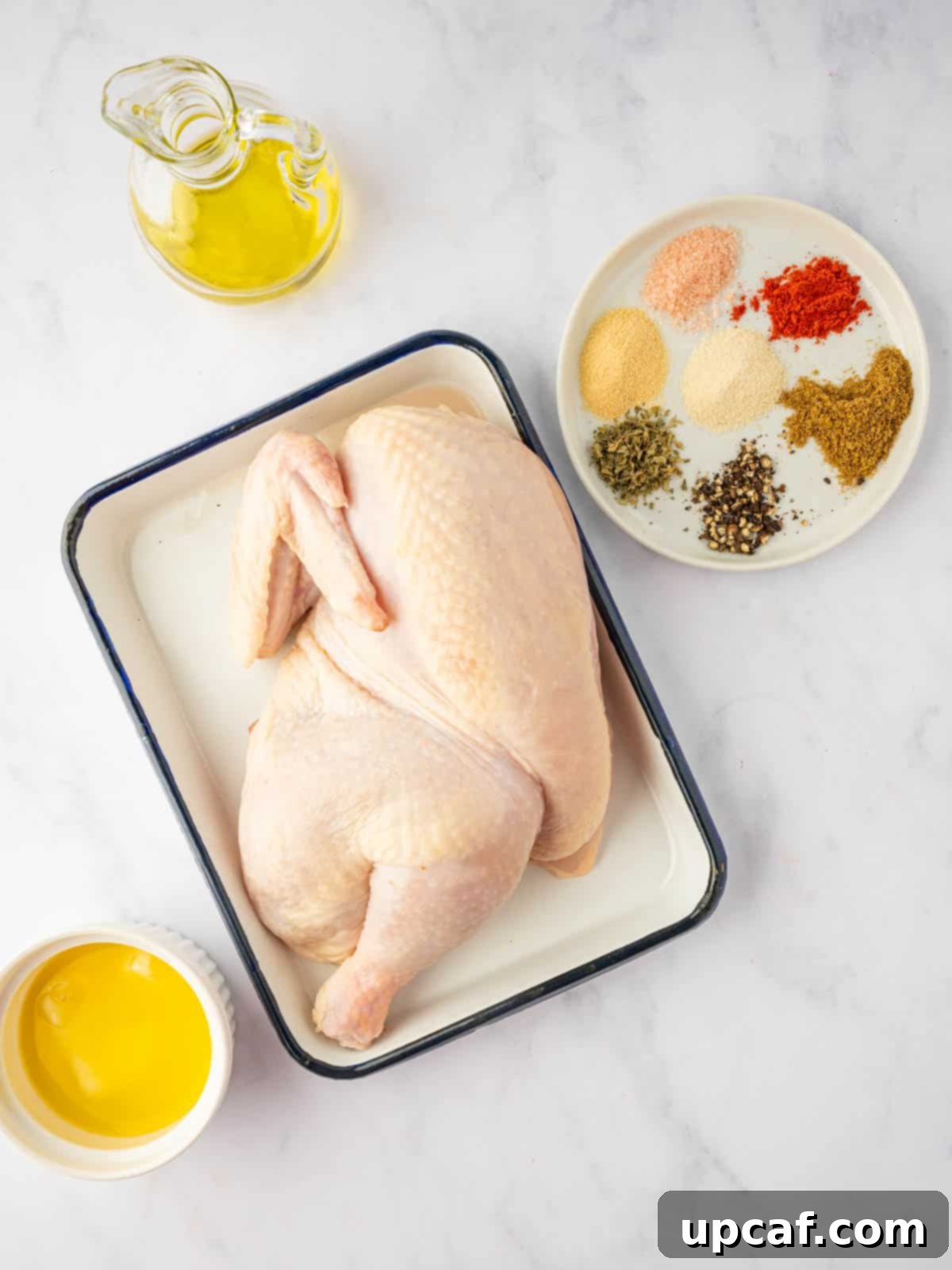 A selection of spices and oil laid out, ready for preparing the BBQ half chicken marinade.