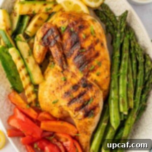 A grilled half chicken on a platter.