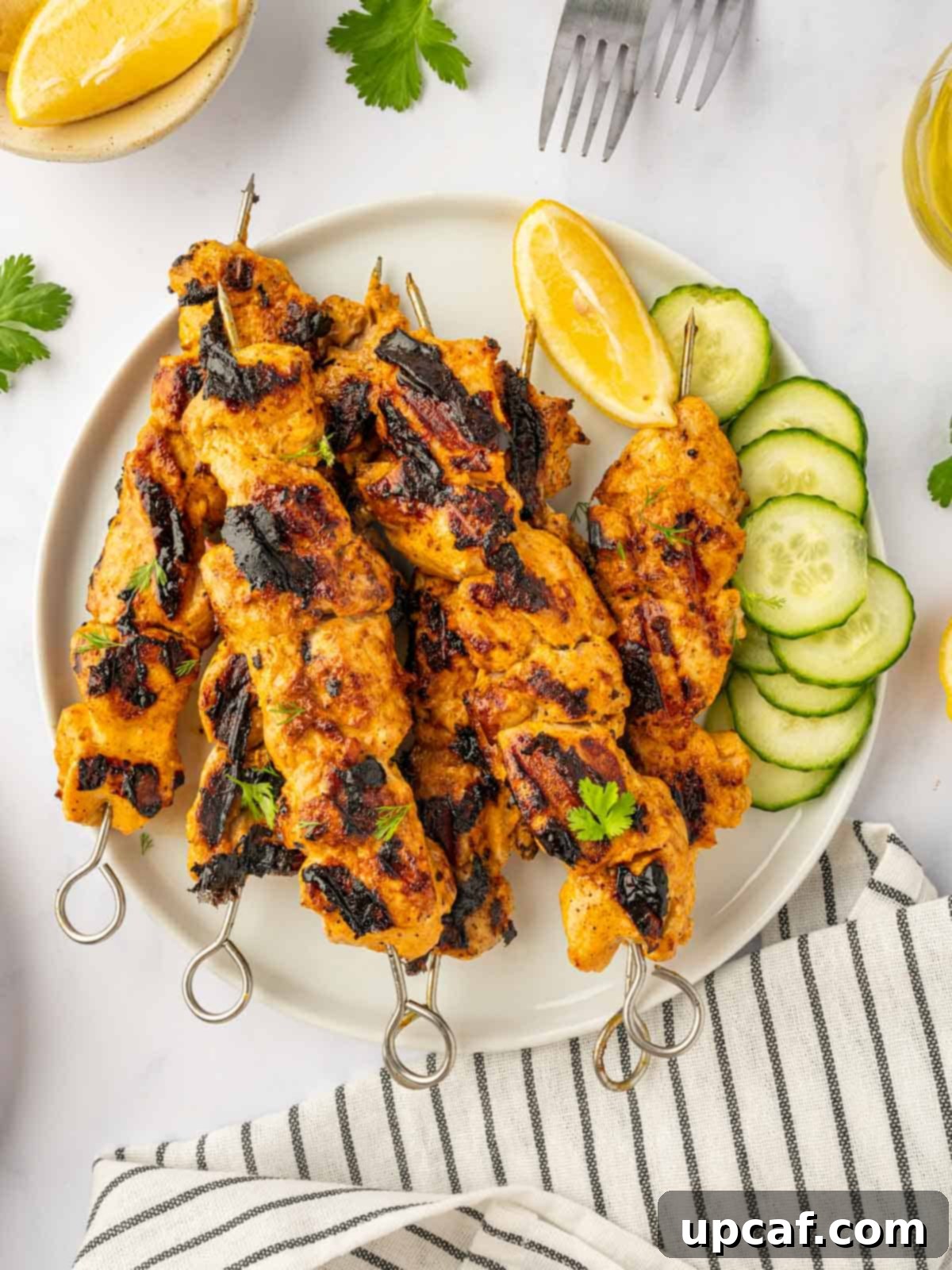 Perfectly charred and succulent Tandoori Chicken Skewers ready to be served on a rustic platter.