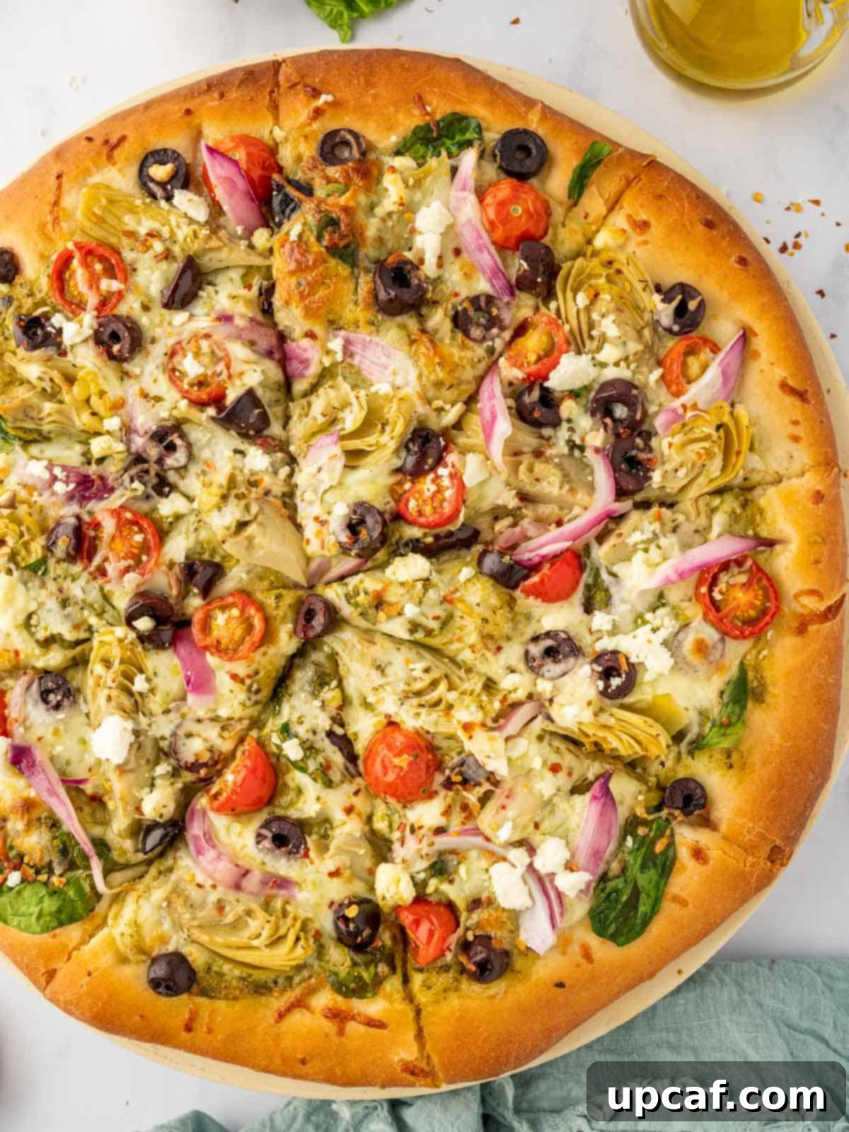 Mediterranean pizza cut into 8 slices.