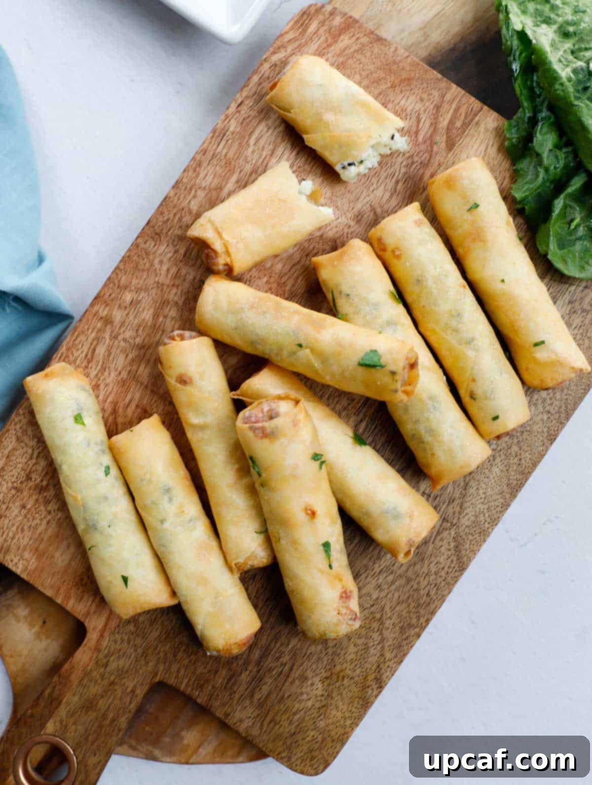 Fried Lebanese Cheese Rolls on a wooden board, showcasing their golden crispiness.